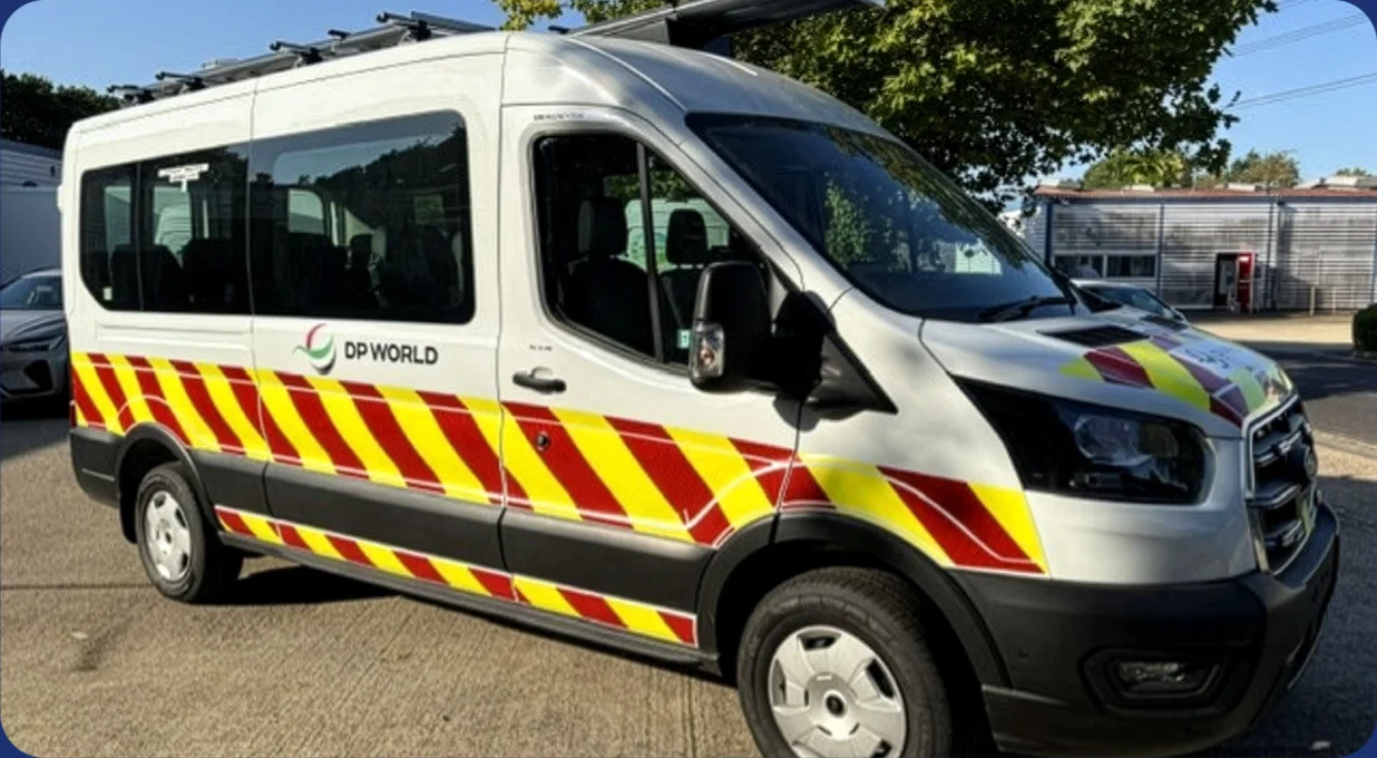Electric minibus in business fleet livery